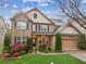 Beautiful two-story brick home with a manicured lawn, colorful landscaping, and an attached two-car garage at 2539 Larson Creek Cv, Duluth, GA 30097