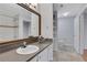 Bright bathroom with a large mirror, vanity, and walk-in shower with decorative tile at 1101 Juniper Ne St # 619, Atlanta, GA 30309
