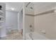 Cozy bathroom featuring a white tiled shower and tub, and a neutral accent stripe at 1101 Juniper Ne St # 619, Atlanta, GA 30309