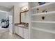 Well-lit bathroom featuring a vanity, sink, and convenient shelving for ample storage at 1101 Juniper Ne St # 619, Atlanta, GA 30309