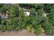 Aerial view of the property surrounded by lush trees and backing to the lake at 132 Lakeshore Dr, Roswell, GA 30075