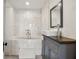 Elegant bathroom featuring a marble-tiled shower, modern vanity, and neutral finishes at 132 Lakeshore Dr, Roswell, GA 30075