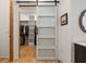 Walk-in closet with custom shelving, a frosted sliding door, and ample storage at 132 Lakeshore Dr, Roswell, GA 30075