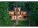 Contemporary home with expansive windows and a large deck nestled amongst mature trees at 132 Lakeshore Dr, Roswell, GA 30075