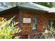 Exterior view of the rustic-style home featuring wood shingles and greenery at 132 Lakeshore Dr, Roswell, GA 30075