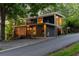 Modern house exterior with unique design elements and a sloped driveway, surrounded by greenery at 132 Lakeshore Dr, Roswell, GA 30075