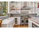 Modern kitchen featuring white cabinetry, stainless steel appliances, and granite countertops at 132 Lakeshore Dr, Roswell, GA 30075