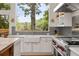 Modern kitchen with white cabinetry, stainless steel appliances, and a view of the serene landscape at 132 Lakeshore Dr, Roswell, GA 30075