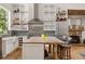 Well-appointed kitchen with custom cabinets, stone fireplace, stainless steel appliances, and butcher block island at 132 Lakeshore Dr, Roswell, GA 30075