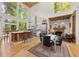 Bright and airy kitchen featuring a large island, stone fireplace, and expansive windows at 132 Lakeshore Dr, Roswell, GA 30075