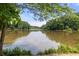 Scenic view of a tranquil lake surrounded by lush greenery and clear blue skies at 132 Lakeshore Dr, Roswell, GA 30075