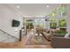 Bright living room with hardwood floors, modern furniture, and large windows with a deck view at 132 Lakeshore Dr, Roswell, GA 30075