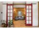 Living area with decorative red sliding doors, wood-paneled wall and comfortable seating at 132 Lakeshore Dr, Roswell, GA 30075