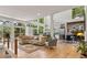 Spacious living room with large windows, modern decor, hardwood floors, open to kitchen and dining at 132 Lakeshore Dr, Roswell, GA 30075