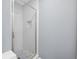 Updated bathroom features glass enclosed shower with rain head shower fixture at 2470 Hillvale Cir, Lithonia, GA 30058