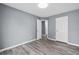 Neutral bedroom showcasing hard surface floors, fresh paint, and convenient access to a hallway at 2470 Hillvale Cir, Lithonia, GA 30058
