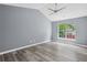 Bright bedroom features vaulted ceiling, ceiling fan, large window and beautiful wood-look flooring at 2470 Hillvale Cir, Lithonia, GA 30058