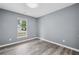 Bedroom with wood-look floors and a bright window at 2470 Hillvale Cir, Lithonia, GA 30058