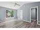 Bright bedroom features vaulted ceiling, ceiling fan, large window and beautiful wood-look flooring at 2470 Hillvale Cir, Lithonia, GA 30058
