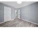 Bedroom with wood-look floors, neutral paint and access to the ensuite bathroom at 2470 Hillvale Cir, Lithonia, GA 30058