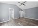 Bedroom with beautiful wood-look floors, vaulted ceilings, ensuite bathroom, and neutral paint at 2470 Hillvale Cir, Lithonia, GA 30058