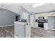 Modern kitchen featuring stainless steel appliances, white cabinetry, and stylish backsplash at 2470 Hillvale Cir, Lithonia, GA 30058