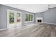 Bright living room featuring French doors and a cozy fireplace with a marble surround at 2470 Hillvale Cir, Lithonia, GA 30058