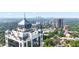 Daytime aerial view shows building surrounded by lush greenery, offering serene environment close to city life at 2828 Peachtree Nw Rd # P 3300, Atlanta, GA 30305