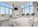 Sunlit bedroom features decorative bed, TV, and access to an outdoor patio at 2828 Peachtree Nw Rd # P 3300, Atlanta, GA 30305
