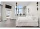Sunlit bedroom boasts a decorative bed, a mounted TV, and an en suite bathroom at 2828 Peachtree Nw Rd # P 3300, Atlanta, GA 30305