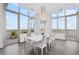 Bright dining room featuring floor-to-ceiling windows, a modern chandelier, and access to an outdoor balcony at 2828 Peachtree Nw Rd # P 3300, Atlanta, GA 30305