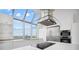 Sleek kitchen has stainless appliances, stylish range hood, white cabinets, and many windows at 2828 Peachtree Nw Rd # P 3300, Atlanta, GA 30305
