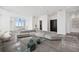 Open-concept living room with modern sofa, glass tables, and large windows showcasing natural light at 2828 Peachtree Nw Rd # P 3300, Atlanta, GA 30305