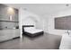 Bright main bedroom features a king-size bed, concrete accent wall, and modern finishes at 2828 Peachtree Nw Rd # P 3300, Atlanta, GA 30305
