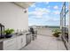 A luxurious outdoor kitchen on a patio offers a sink, dishwasher, and stunning city views at 2828 Peachtree Nw Rd # P 3300, Atlanta, GA 30305