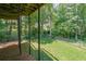 A view from the deck towards the backyard with grassy area and trees at 1403 Benbrooke Circle Northwest Nw Cir, Acworth, GA 30101