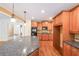 Kitchen with wood cabinets, granite countertops, stainless steel appliances, tile backsplash and hardwood floors at 1403 Benbrooke Circle Northwest Nw Cir, Acworth, GA 30101