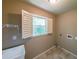 Functional laundry room featuring a utility sink, natural light, and washer/dryer hookups at 1403 Benbrooke Circle Northwest Nw Cir, Acworth, GA 30101