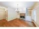 Living Room boasts a stone fireplace, built in bookshelves, hardwood floors, and shuttered windows at 1403 Benbrooke Circle Northwest Nw Cir, Acworth, GA 30101