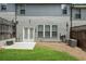 Cozy backyard featuring a small patio, green grass, a privacy fence, and building exterior at 228 Stone Park Dr, Woodstock, GA 30188