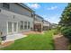 Well-maintained backyard with green grass, a small patio, and a view of the building's exterior at 228 Stone Park Dr, Woodstock, GA 30188