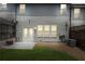 Cozy backyard featuring a small patio, green grass, a privacy fence, and building exterior at 228 Stone Park Dr, Woodstock, GA 30188