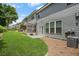 Well-maintained backyard with green grass, a small patio, and a view of the building's exterior at 228 Stone Park Dr, Woodstock, GA 30188