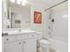 Bright bathroom featuring a large mirror, white vanity, toilet, and shower-tub combination at 228 Stone Park Dr, Woodstock, GA 30188