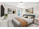 Modern bedroom with a comfortable queen-sized bed, a wall-mounted TV, and modern decor at 228 Stone Park Dr, Woodstock, GA 30188
