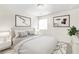 Neutrally decorated bedroom with a comfortable bed, soft lighting, and decorative wall art at 228 Stone Park Dr, Woodstock, GA 30188