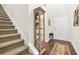 Welcoming foyer featuring hardwood floors, stairs and a display cabinet at 228 Stone Park Dr, Woodstock, GA 30188