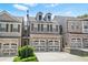 Charming brick townhome with a two-car garage and well-manicured front lawn at 228 Stone Park Dr, Woodstock, GA 30188