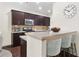 Modern kitchen featuring a breakfast bar, stainless steel appliances, and ample counter space at 228 Stone Park Dr, Woodstock, GA 30188