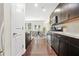 Bright kitchen with stainless appliances, dark wood cabinets, and an adjacent dining area with natural light at 228 Stone Park Dr, Woodstock, GA 30188